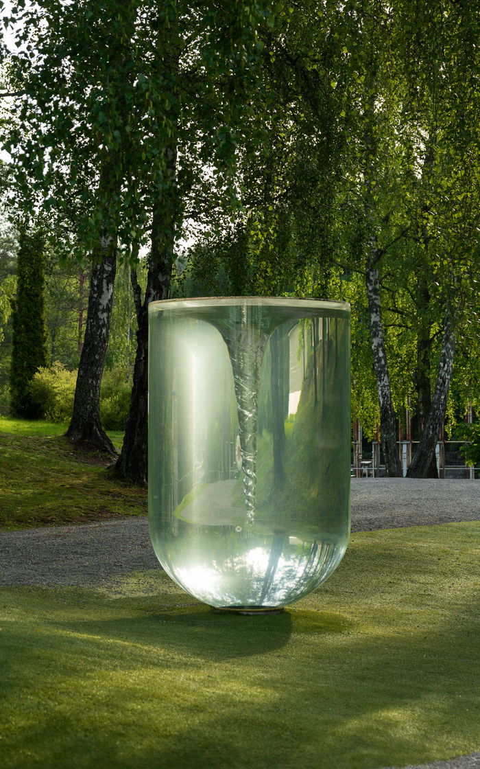 Sculpture consisting of a large transparent container filled with mineral oil, creating a whirling spine.
